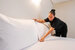 image of housekeeper making the bed